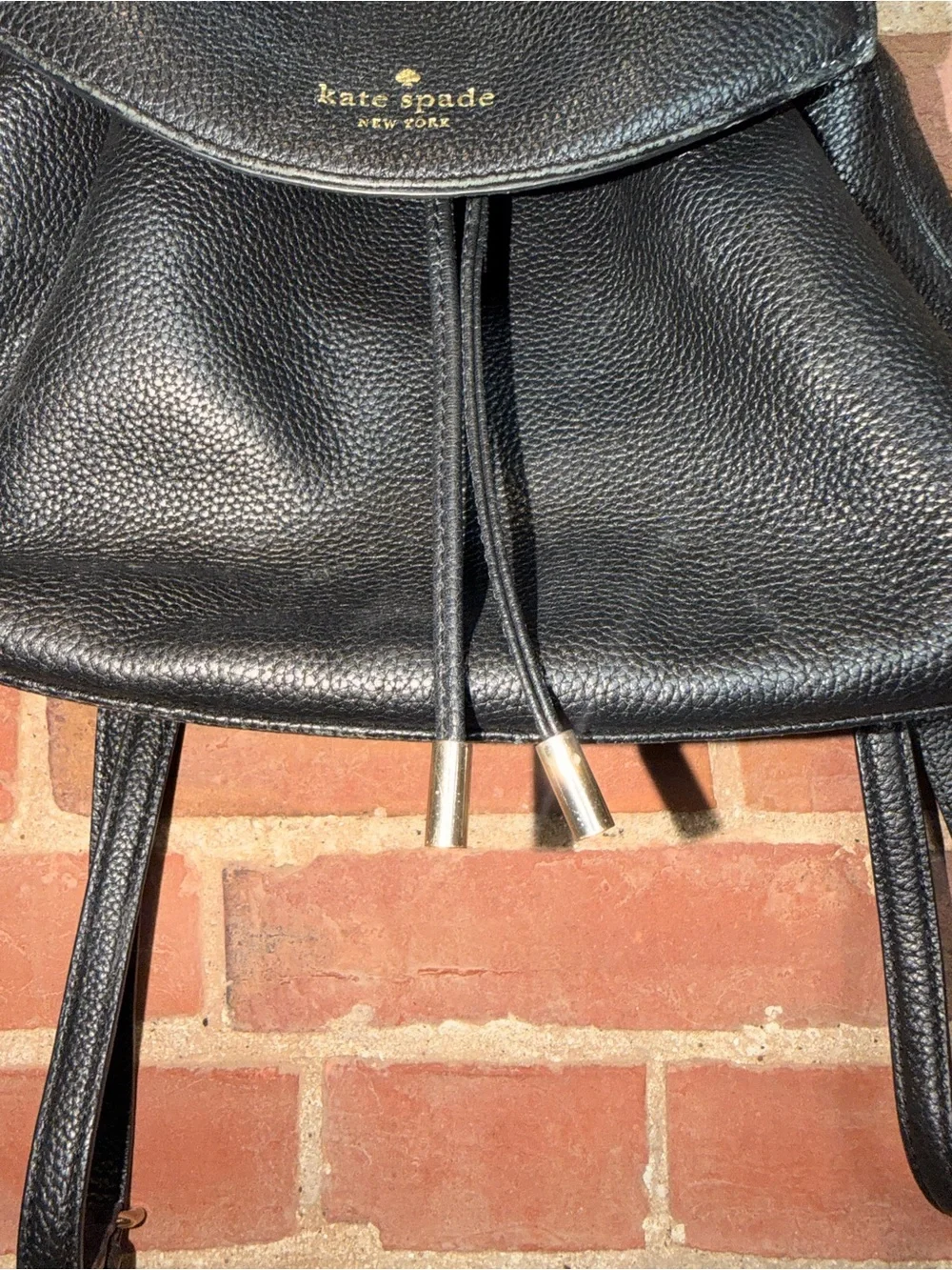 kate spade black pebbled leather flap drawstring backpack